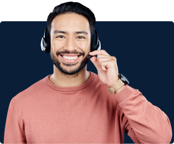 Male support specialist smiling while discussing project on the phone