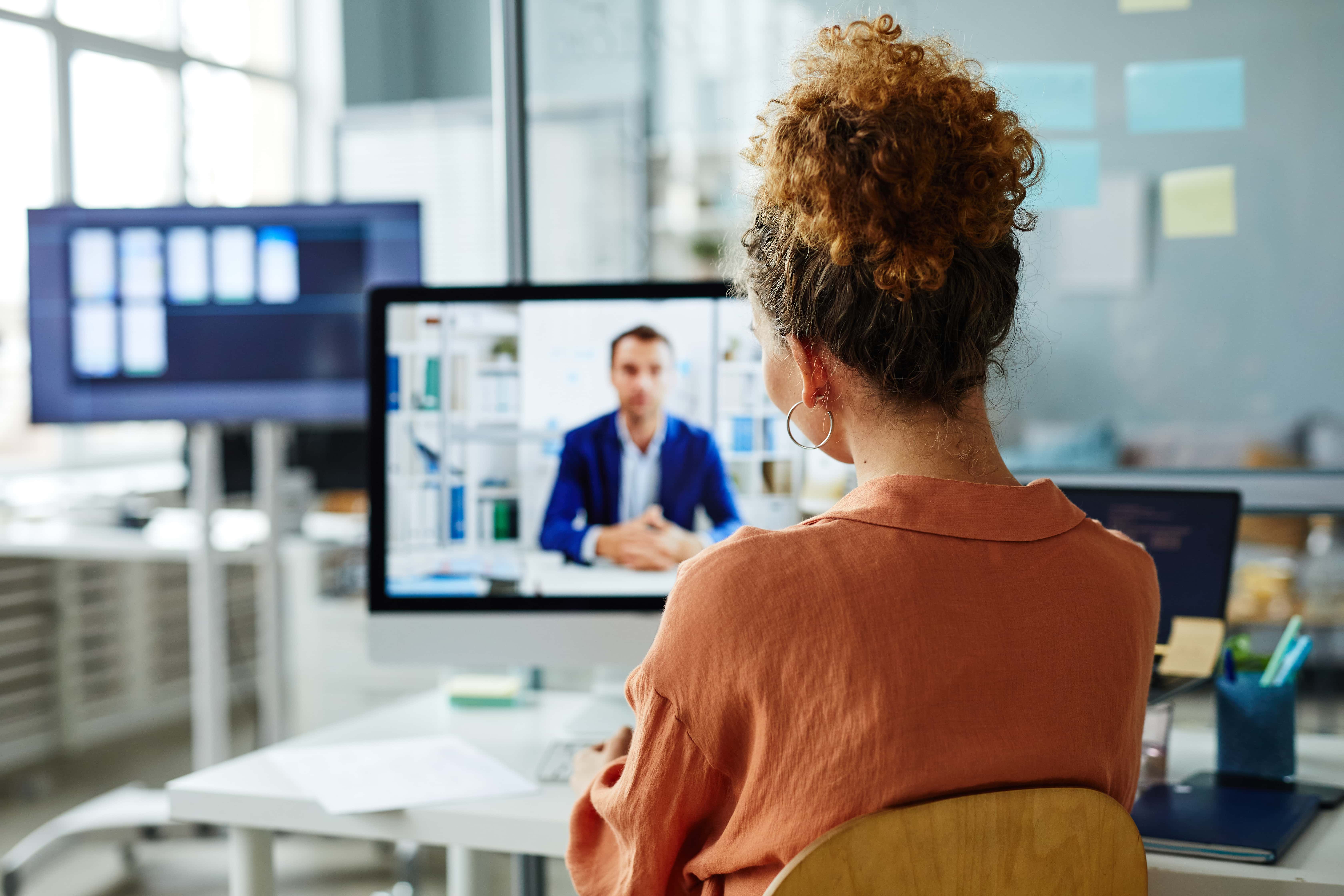 Happy woman providing excellent customer service, reviewing project on screen